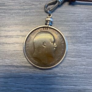 Collector coin in bezel. Necklace is leather and turquoise bead.